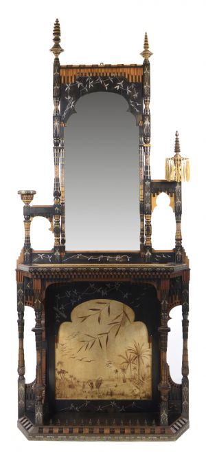 Carlo Bugatti / Konzolový stůl se zrcadlem / zač. 20. stol. dřevo, intarzie perletí a kovem, měděné reliéfní vložky, pergamen   260 x 111 x 38 cm vyvolávací cena: 1 121 000 Kč